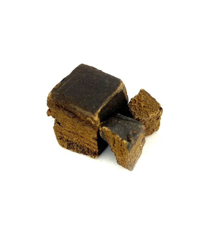 Dark black hash block with rich texture, Warren Peace premium cannabis concentrate