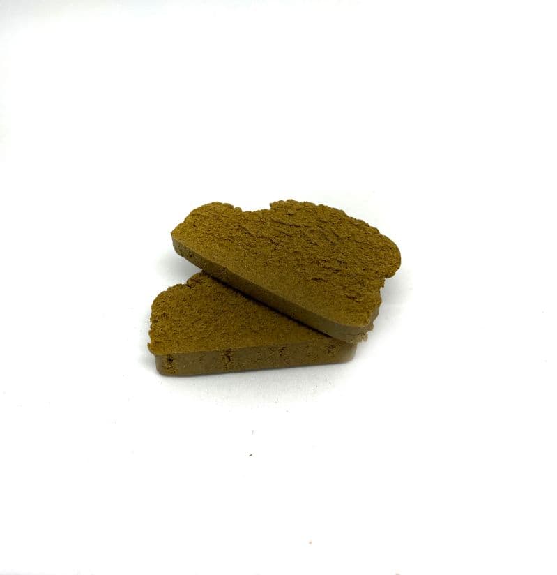 Blonde Lebanese hash block with golden tan coloring, firm pressed texture, traditional Middle Eastern cannabis concentrate