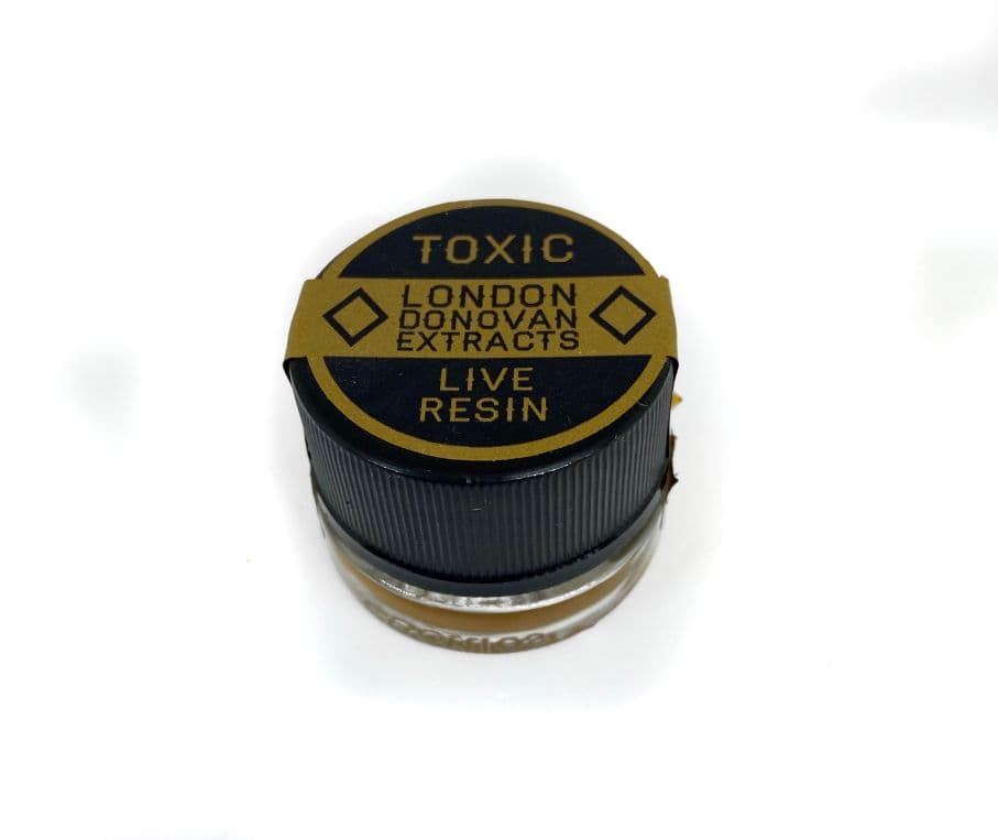 Toxic Live Resin cannabis concentrate by 120, golden amber extract in a small glass jar