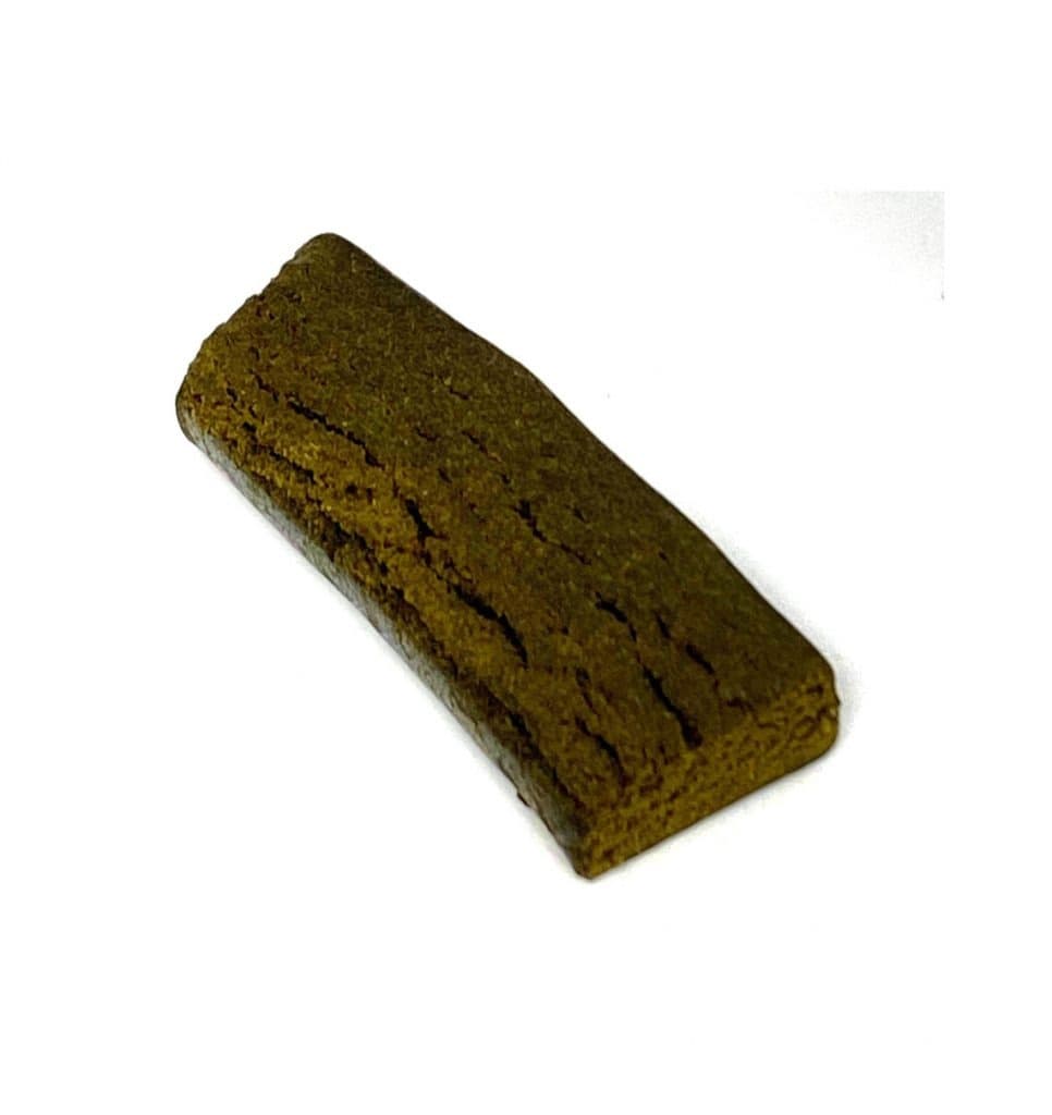 Dark brown cylindrical Tootsie Roll shaped hash piece with rich texture resembling the classic candy form