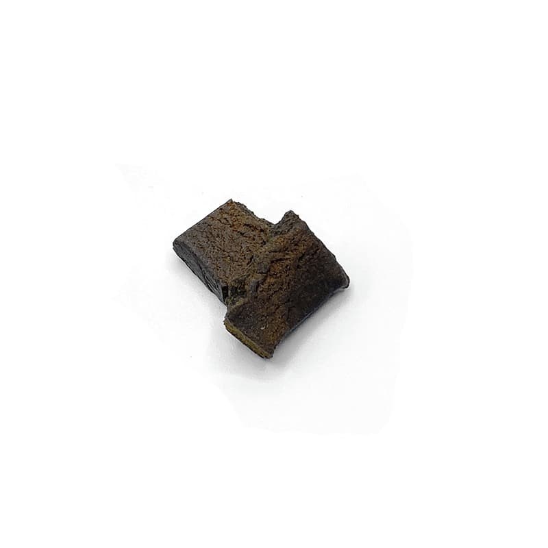 Dark brown Moroccan hash block with earthy texture, traditional pressed cannabis concentrate