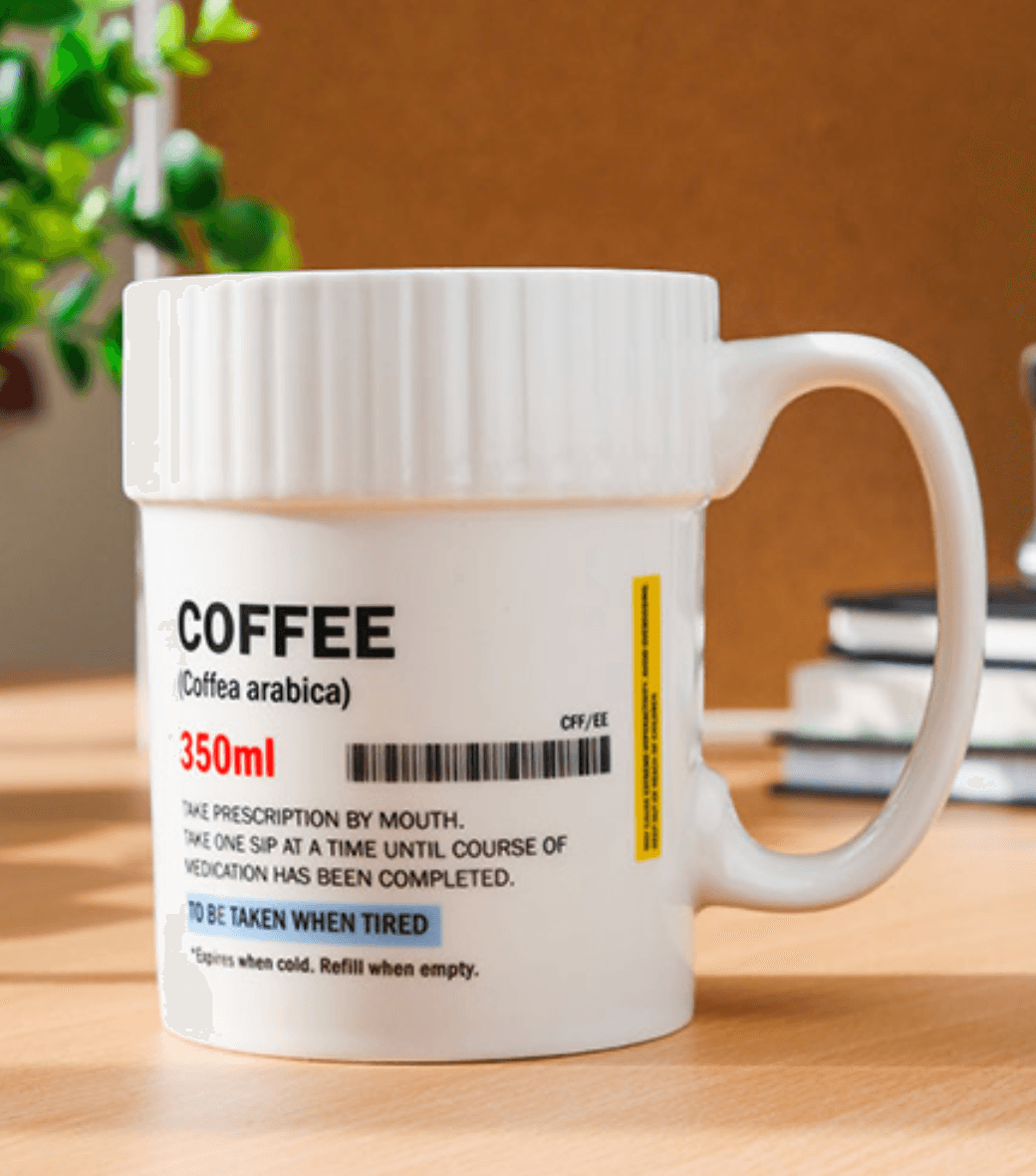 White ceramic coffee mug featuring a prescription label design, ideal for coffee lovers who need their daily dose