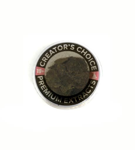 Dark brown finger hash concentrate rolled into a cylinder shape, a traditional hand-pressed cannabis extract