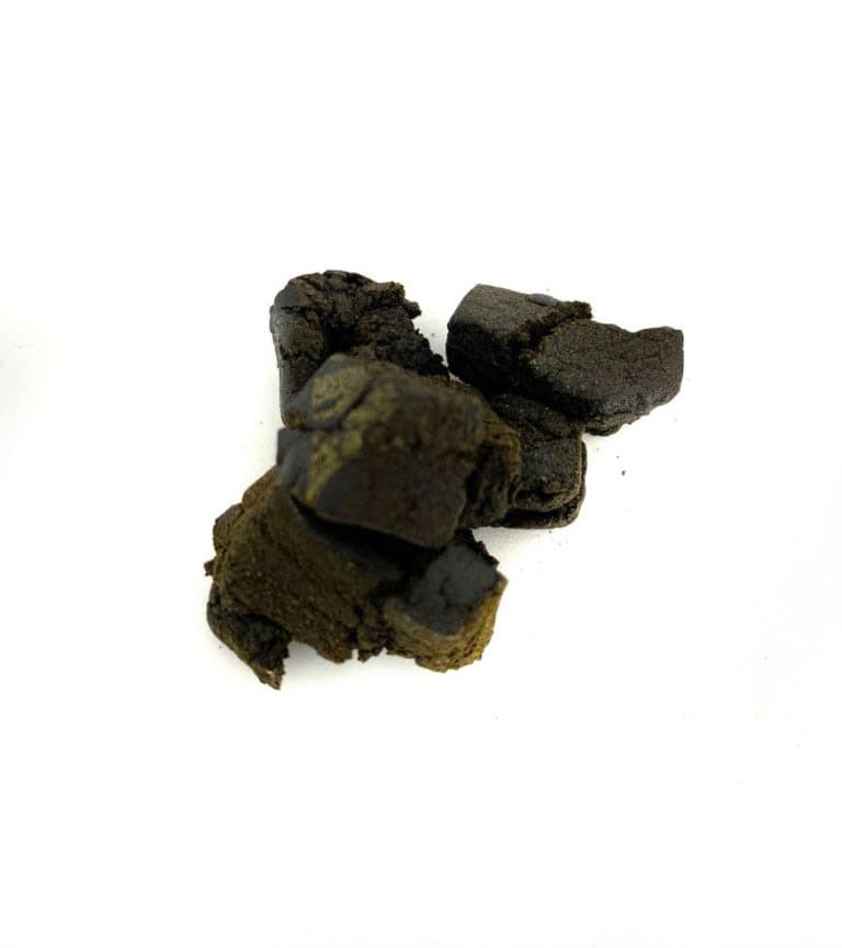 Dark black hash concentrate with a gold crown logo from Gold Crown brand premium cannabis hash product