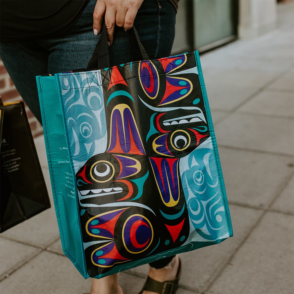 Large eco-friendly recycled tote bag featuring a thunderbird and whale design