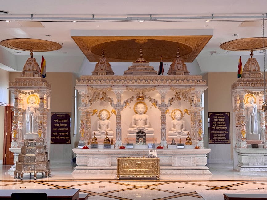 Beautiful interior of a Jain temple in Brampton, showcasing intricate marble statues and ornate architecture.