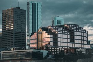Edmonton skyline showcasing modern architecture with prominent skyscrapers and urban landscape at dusk.