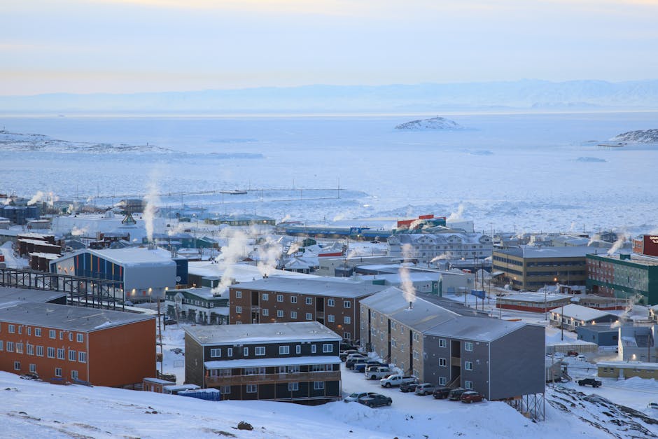 A panoramic winter view of Iqaluit, Nunavut, capturing arctic architecture in a snowy landscape.