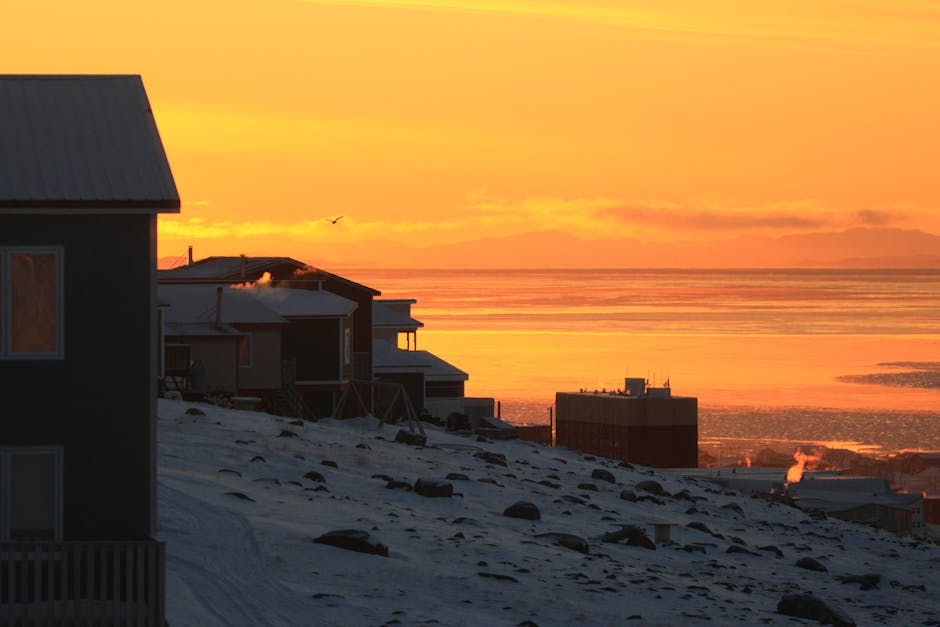 Gorgeous winter sunset illuminating Iqaluit townscape with vibrant colors.