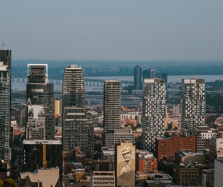 Aerial view of Montreal's skyline featuring the iconic Jacques Cartier Bridge in summer.