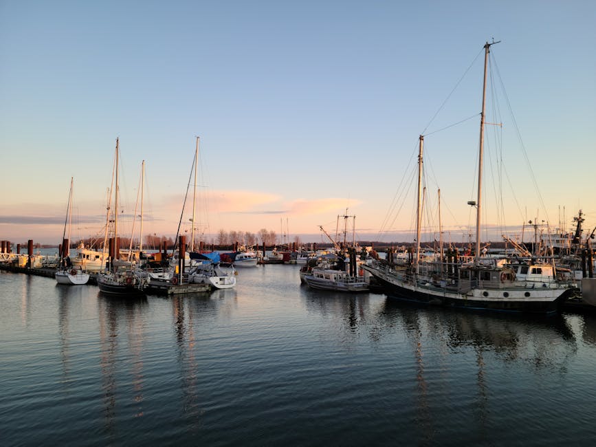 Explore a tranquil marina with boats and sailboats docked under a peaceful sunset sky in Richmond, BC, Canada.