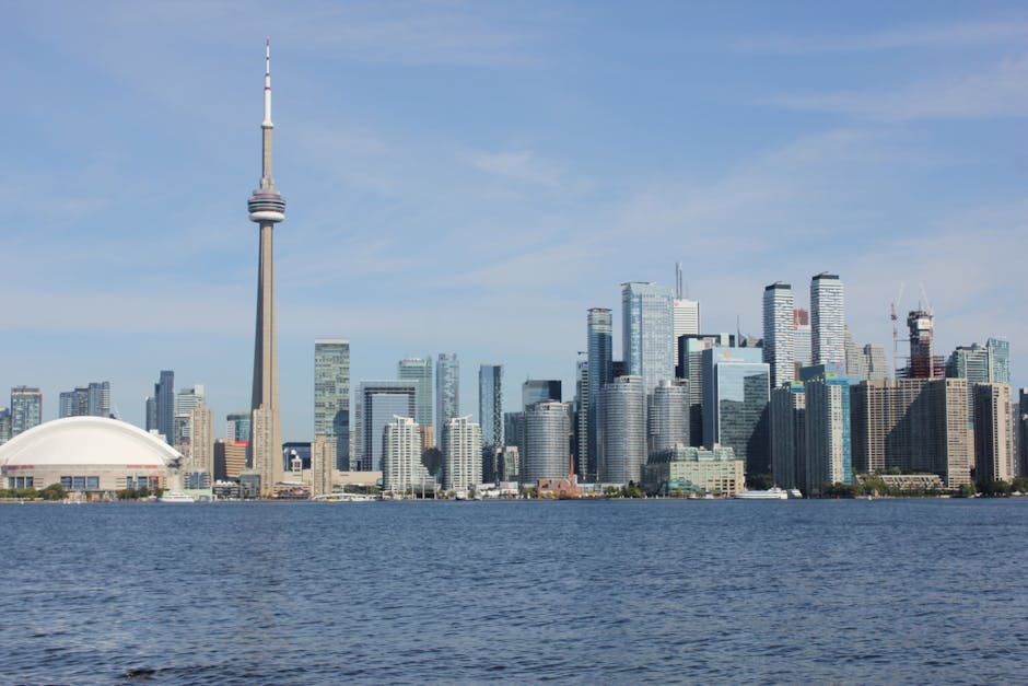 A breathtaking view of Toronto's skyline featuring the iconic CN Tower and cityscape over Lake Ontario.