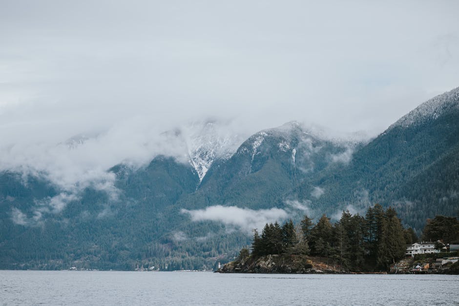 Serene misty mountain landscape with island and trees in West Vancouver, BC.