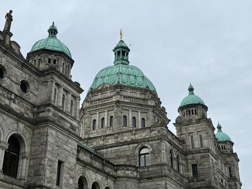 A close-up view of the historic Parliament Building in Victoria, British Columbia with its iconic green domes.