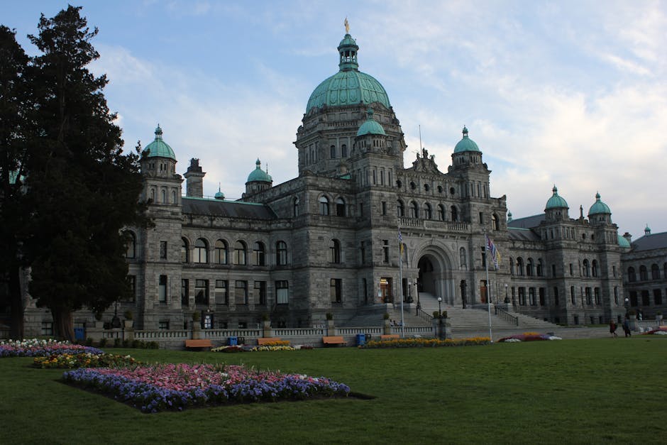 Explore the majestic architecture of the Victoria BC Parliament Building surrounded by lush gardens.